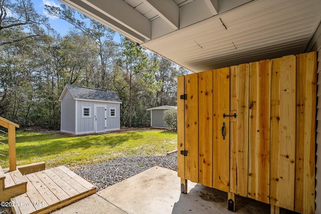 view of yard featuring a storage unit and a patio