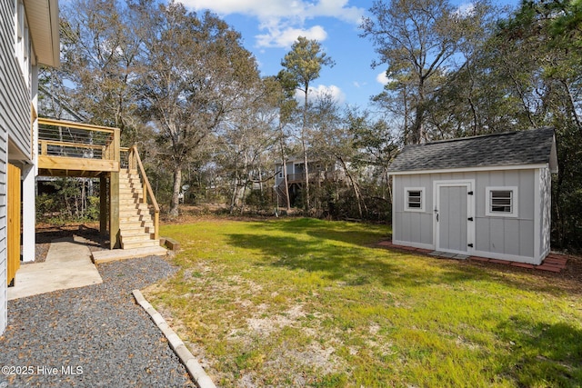 view of yard featuring a wooden deck and a storage unit