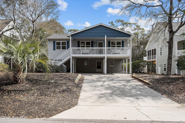 raised beach house with a carport and a porch