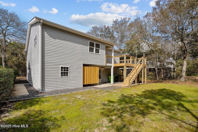 back of property with a deck and a lawn