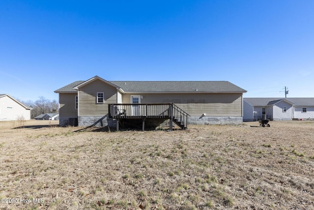 back of house featuring a wooden deck, central AC, and a lawn