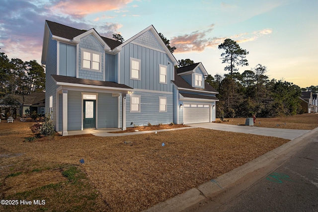 view of front of property featuring a garage and a lawn