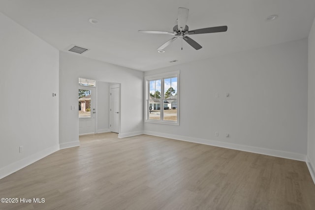 spare room with light hardwood / wood-style flooring, plenty of natural light, and ceiling fan