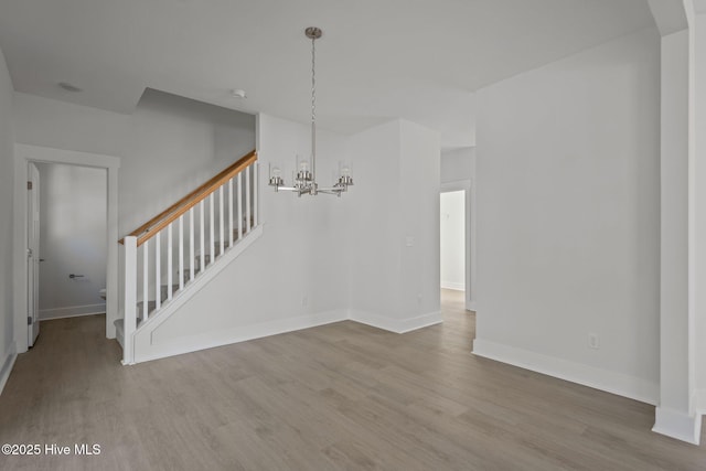 interior space featuring hardwood / wood-style flooring and a chandelier