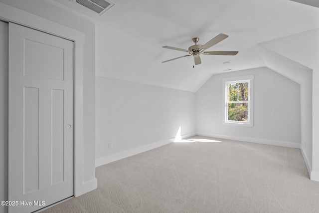 additional living space with light carpet, vaulted ceiling, and ceiling fan