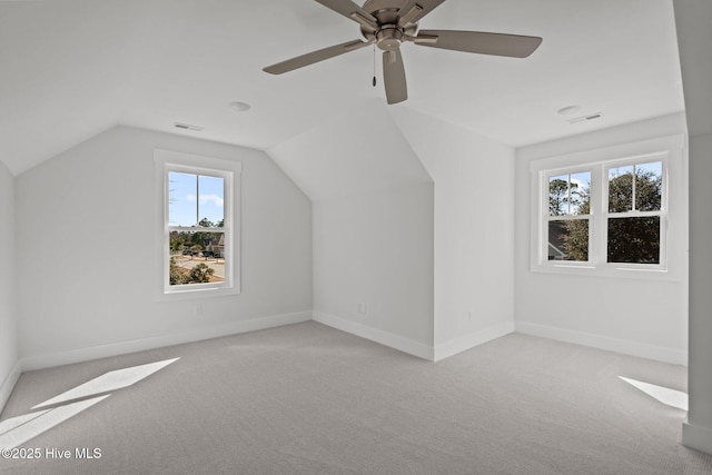 bonus room with vaulted ceiling, light carpet, and ceiling fan