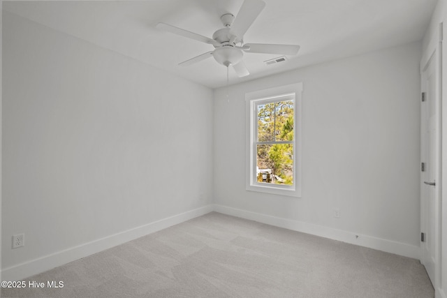 spare room featuring light carpet and ceiling fan