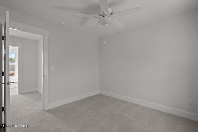 unfurnished room featuring light carpet and ceiling fan