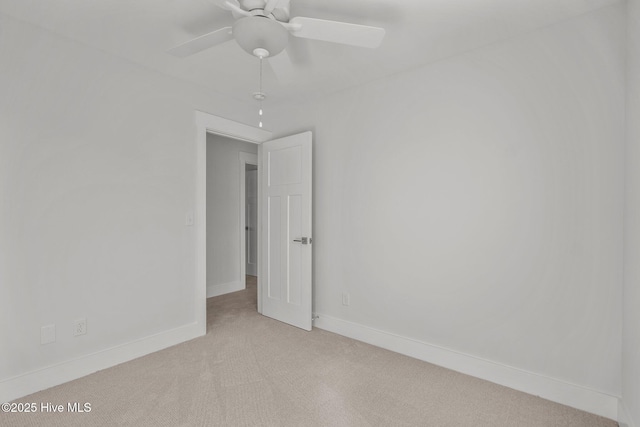 empty room featuring light carpet and ceiling fan