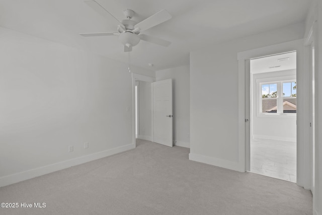 unfurnished room featuring light colored carpet and ceiling fan