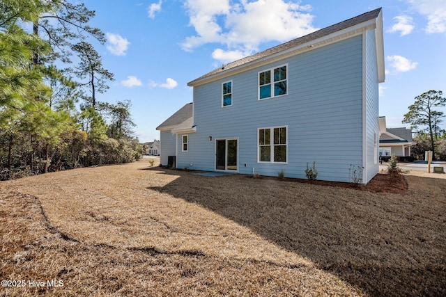 rear view of house with a yard