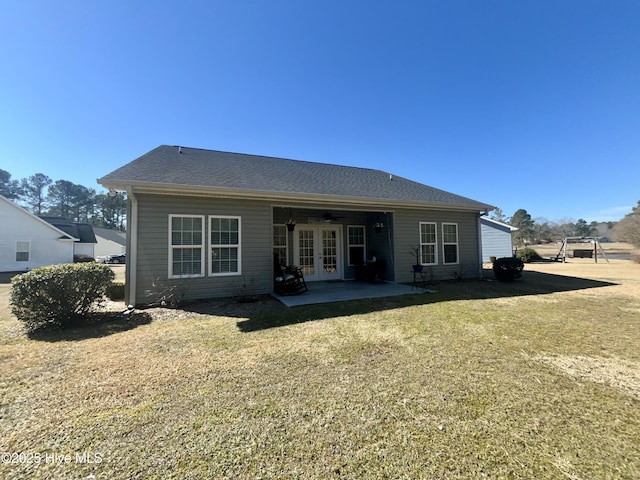 back of property featuring a patio area, french doors, and a lawn