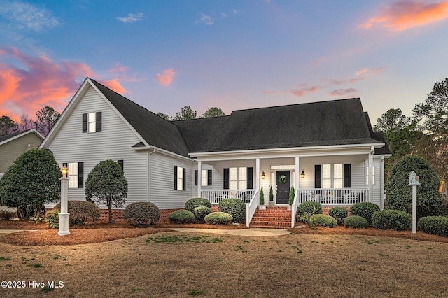 view of front of home with a lawn and a porch