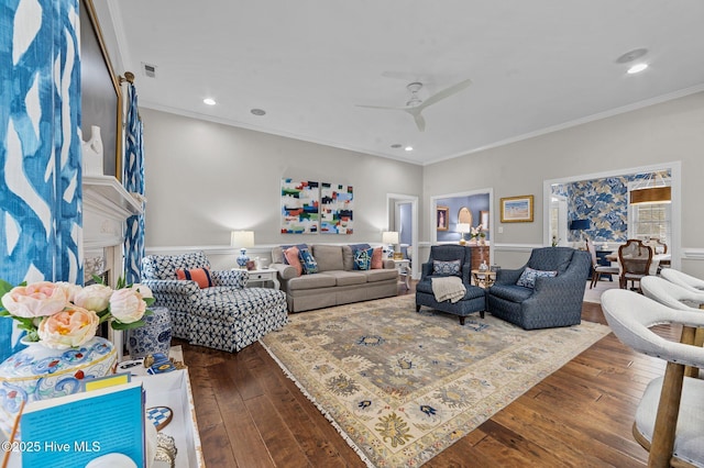 living room with crown molding, ceiling fan, and dark hardwood / wood-style floors