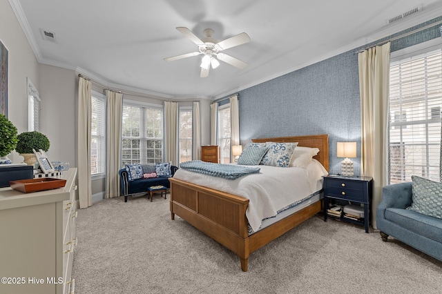 bedroom with crown molding, light colored carpet, and ceiling fan