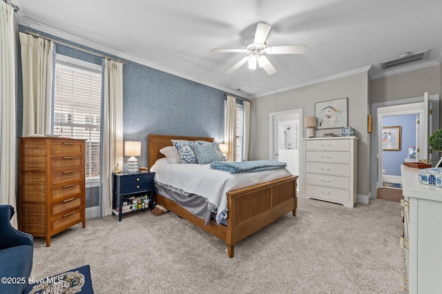 bedroom with multiple windows, crown molding, light carpet, and ensuite bath