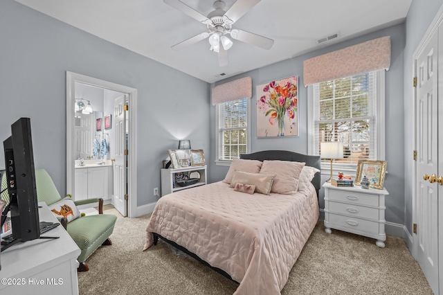 carpeted bedroom with ceiling fan and ensuite bathroom