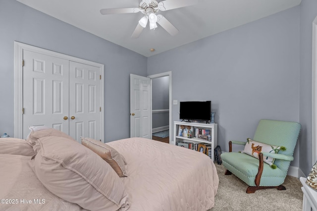 carpeted bedroom with a closet and ceiling fan