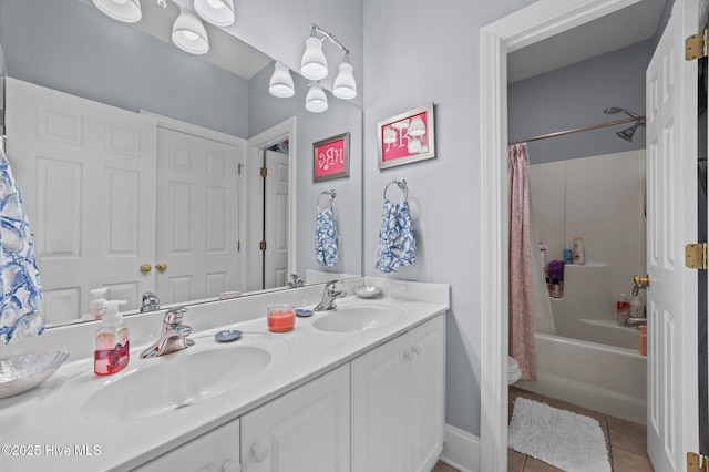 bathroom featuring tile patterned flooring, vanity, and shower / bath combination with curtain