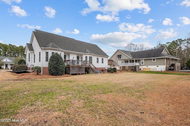 back of house featuring a yard and a deck