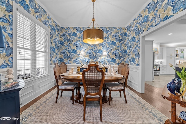 dining space featuring crown molding and wood-type flooring