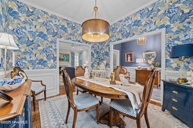 dining area featuring light hardwood / wood-style flooring and ornamental molding