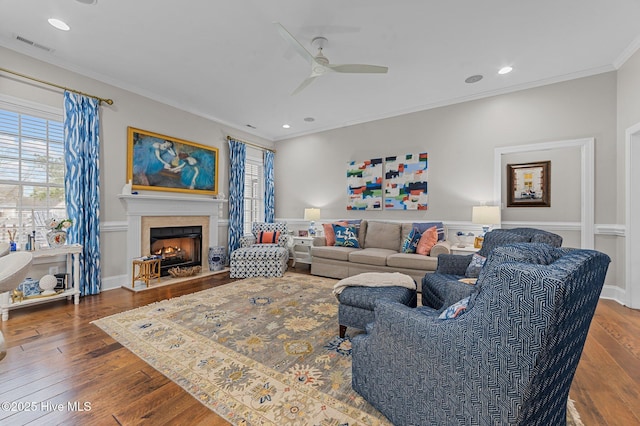 living room featuring a healthy amount of sunlight, ornamental molding, and dark hardwood / wood-style flooring