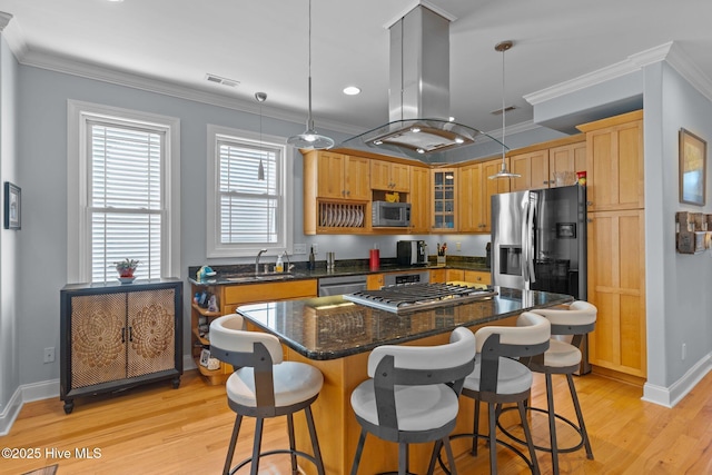 kitchen featuring crown molding, a center island, appliances with stainless steel finishes, pendant lighting, and island exhaust hood