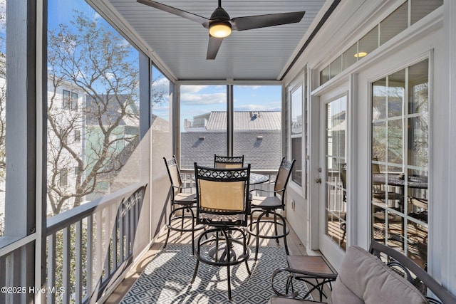 sunroom featuring ceiling fan