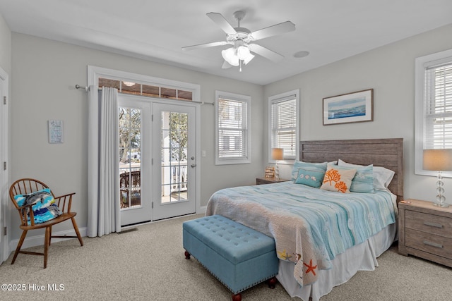 carpeted bedroom featuring ceiling fan, multiple windows, and access to outside