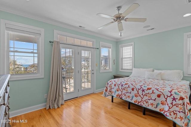 bedroom with ornamental molding, access to exterior, light hardwood / wood-style floors, and multiple windows