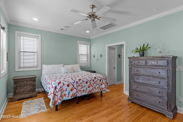 bedroom featuring crown molding, ceiling fan, and light wood-type flooring