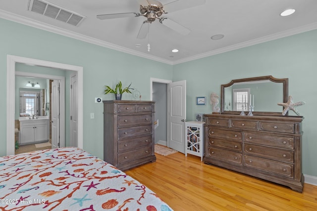 bedroom featuring multiple windows, hardwood / wood-style floors, crown molding, and ensuite bathroom