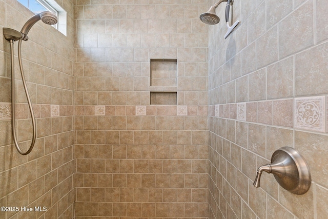 bathroom with tiled shower