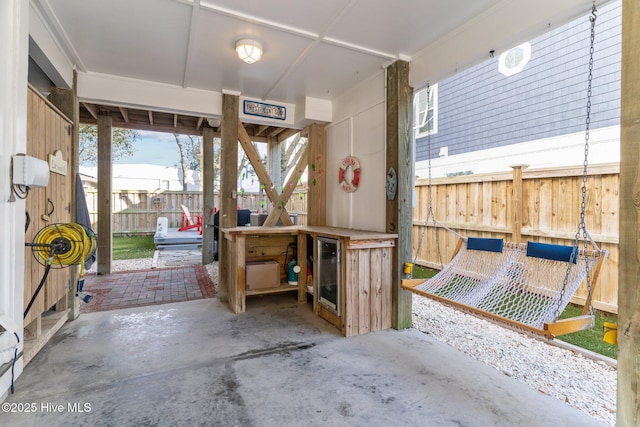 interior space with beverage cooler and concrete flooring