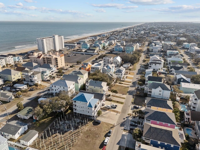 drone / aerial view featuring a view of the beach and a water view