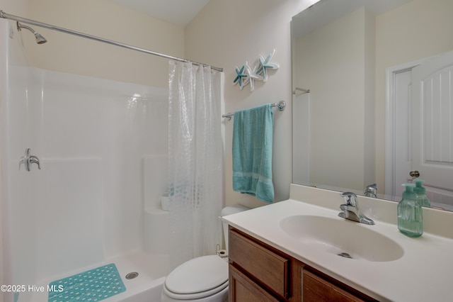 bathroom featuring vanity, toilet, and a shower with shower curtain