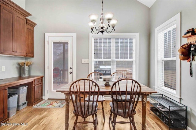 dining area with a notable chandelier and light hardwood / wood-style flooring