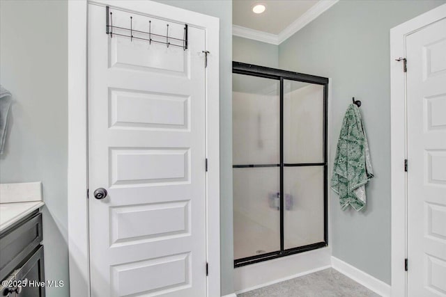 bathroom featuring vanity, crown molding, and walk in shower