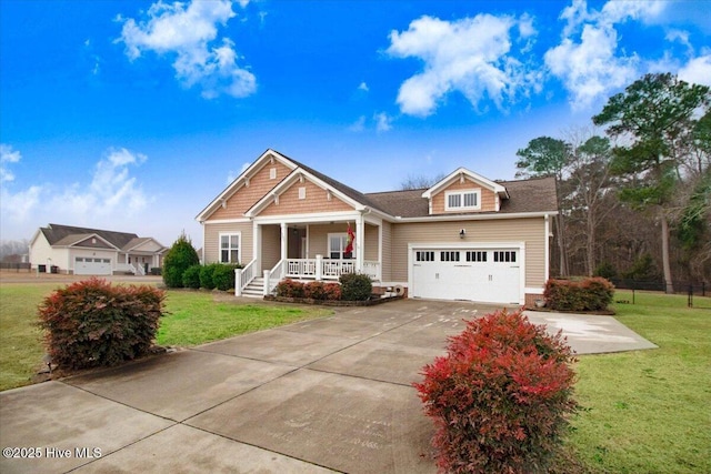 craftsman house with a garage, a front yard, and covered porch