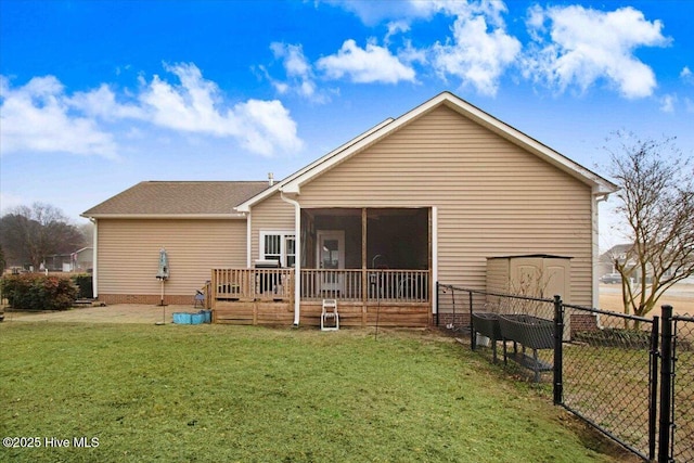 rear view of house featuring a yard and a sunroom