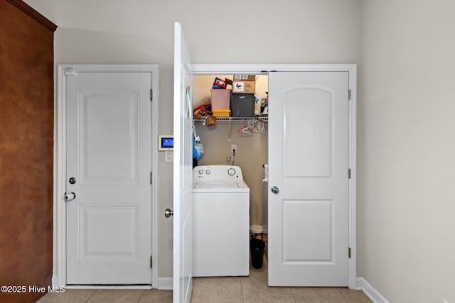 laundry area with washer / clothes dryer and light tile patterned floors