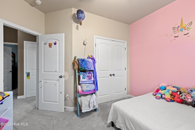 bedroom with light carpet and a closet