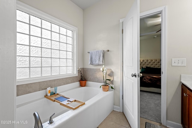 bathroom featuring vanity, a tub to relax in, and tile patterned floors