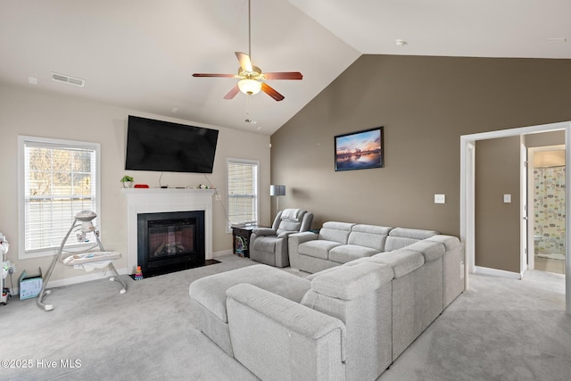 carpeted living room featuring ceiling fan and high vaulted ceiling