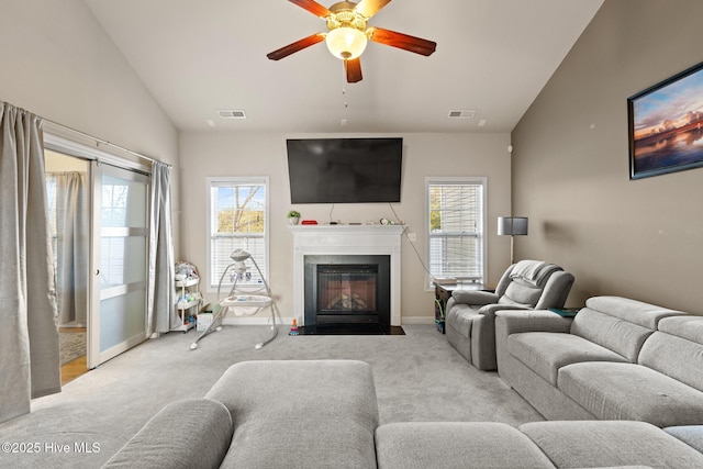 living room with light carpet, a wealth of natural light, lofted ceiling, and ceiling fan