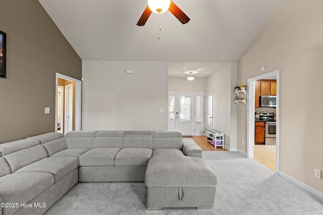 living room featuring carpet, lofted ceiling, and ceiling fan