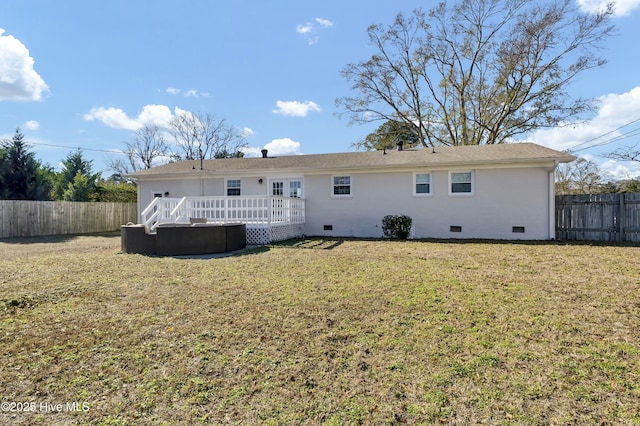 rear view of property with a yard and a deck