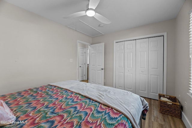 bedroom featuring hardwood / wood-style flooring, a closet, and ceiling fan