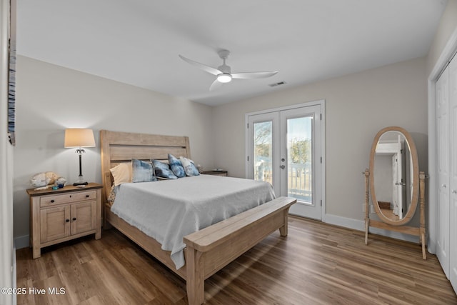 bedroom featuring dark wood-type flooring, ceiling fan, access to exterior, and french doors